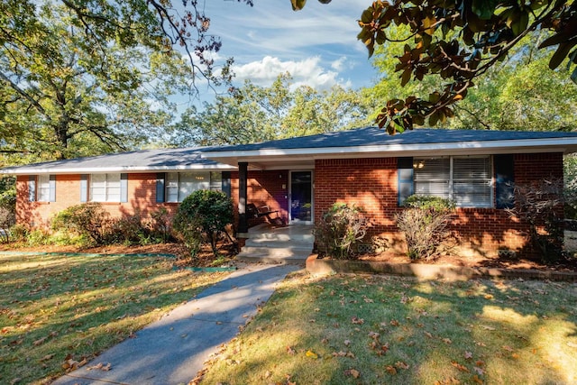 ranch-style house with a front lawn and brick siding