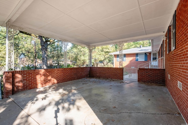 view of patio / terrace featuring a carport and fence