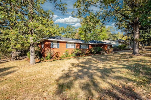 single story home with a front lawn and brick siding