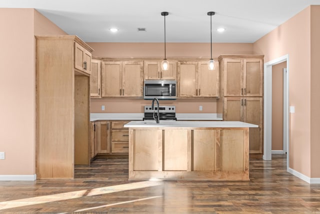 kitchen with stainless steel appliances, a kitchen island with sink, light brown cabinets, and visible vents