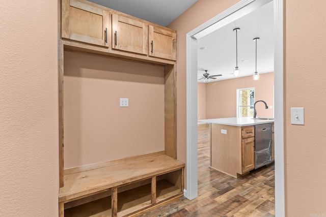 mudroom featuring a ceiling fan, a sink, and wood finished floors