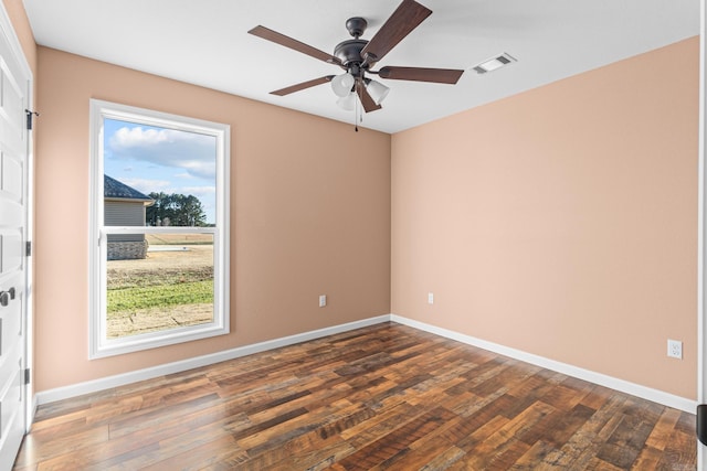 unfurnished room featuring visible vents, baseboards, and wood finished floors