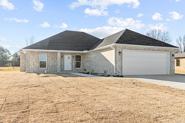 ranch-style home with driveway, a shingled roof, an attached garage, and brick siding