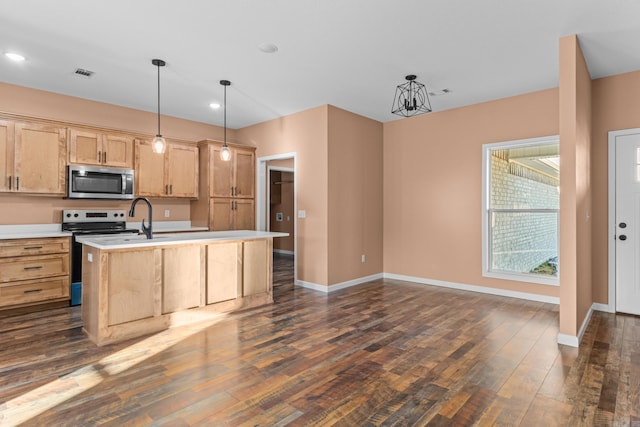 kitchen with stainless steel appliances, dark wood-style flooring, light brown cabinets, and light countertops