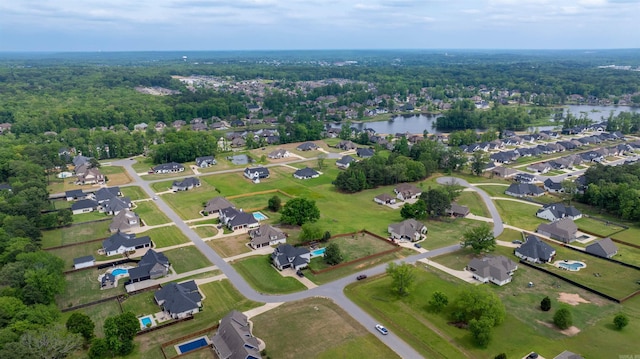 bird's eye view with a residential view, a water view, and a view of trees
