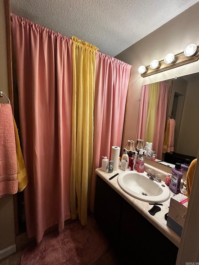 bathroom featuring a textured ceiling and vanity