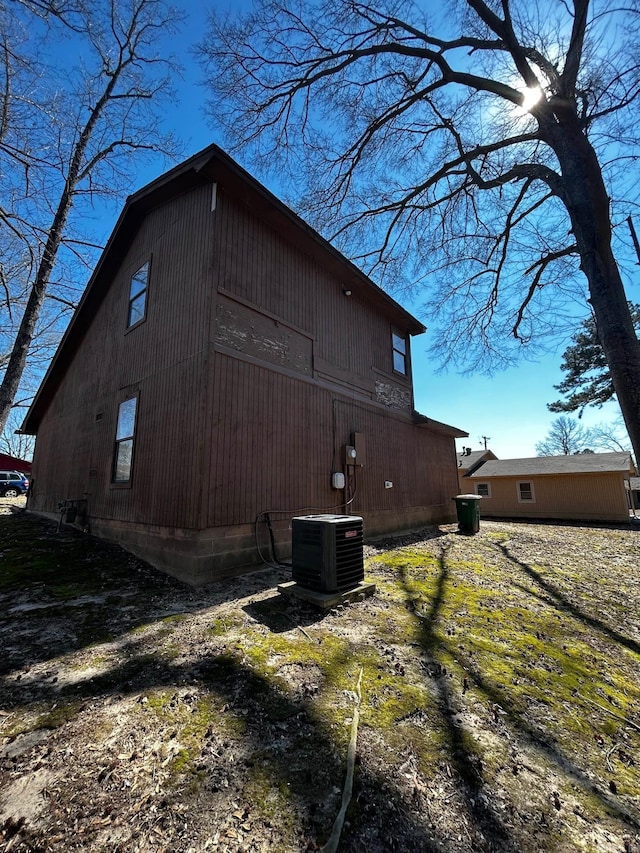 view of side of property with central air condition unit