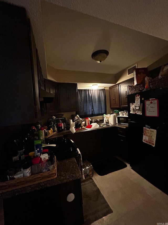 kitchen featuring black appliances, visible vents, and a sink