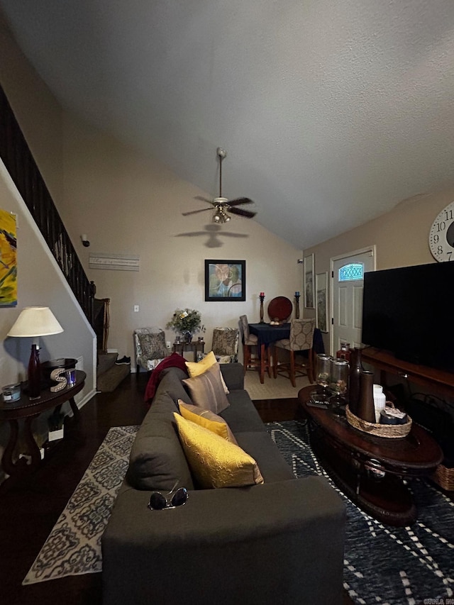 living room with vaulted ceiling, stairway, a textured ceiling, and a ceiling fan