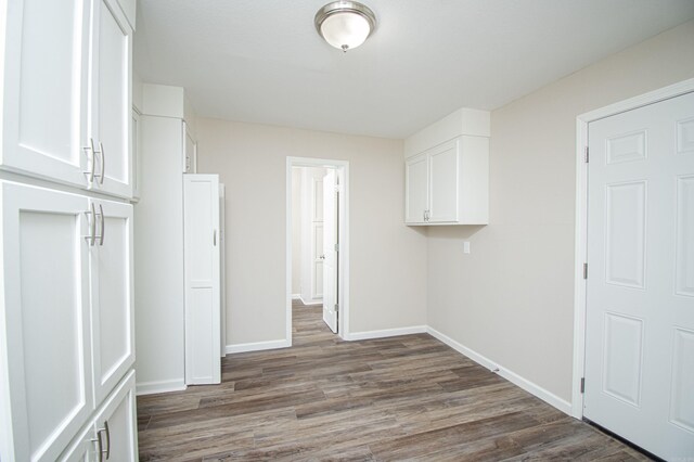 414 W Padgett Rd, El Dorado, AR 71730 - washroom featuring dark wood-type flooring and baseboards