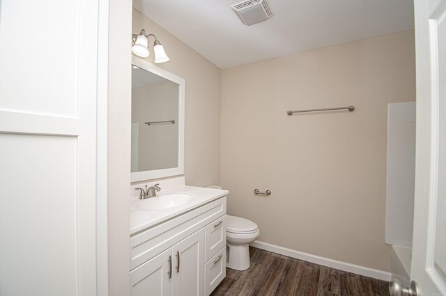 414 W Padgett Rd, El Dorado, AR 71730 - bathroom with toilet, wood finished floors, visible vents, vanity, and baseboards