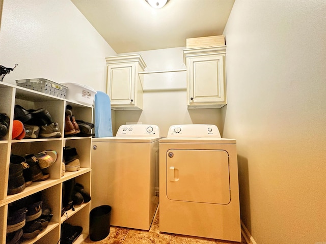 laundry area featuring washing machine and dryer and cabinet space