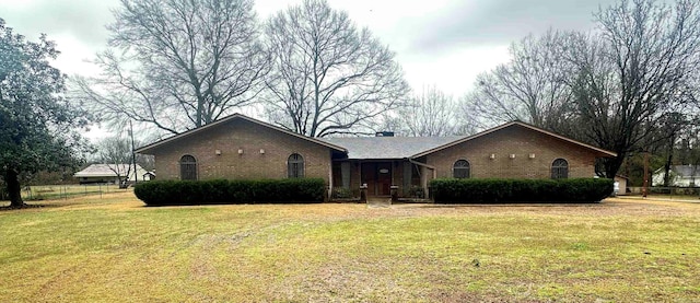 ranch-style house featuring brick siding and a front yard