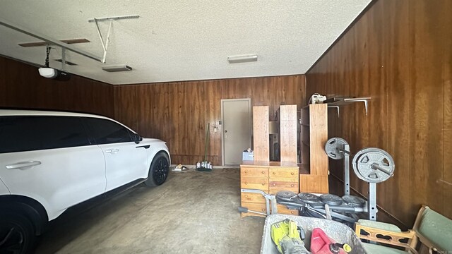 121 W Lee St, Mineral Sprs, AR 71851 - garage featuring wooden walls and a garage door opener