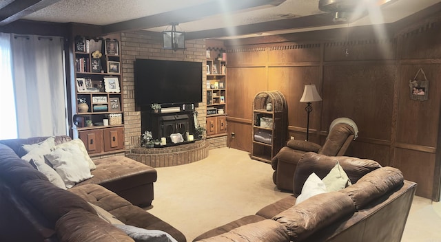 121 W Lee St, Mineral Sprs, AR 71851 - living area featuring carpet flooring, beamed ceiling, a textured ceiling, and a fireplace