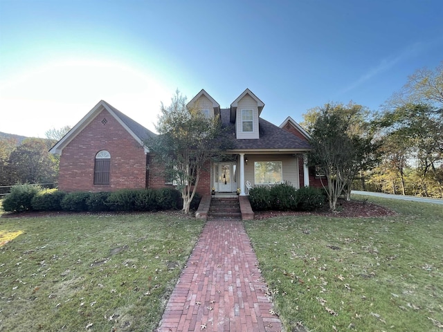 view of front of property with a front yard and brick siding