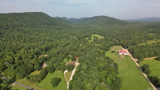 birds eye view of property featuring a mountain view and a view of trees