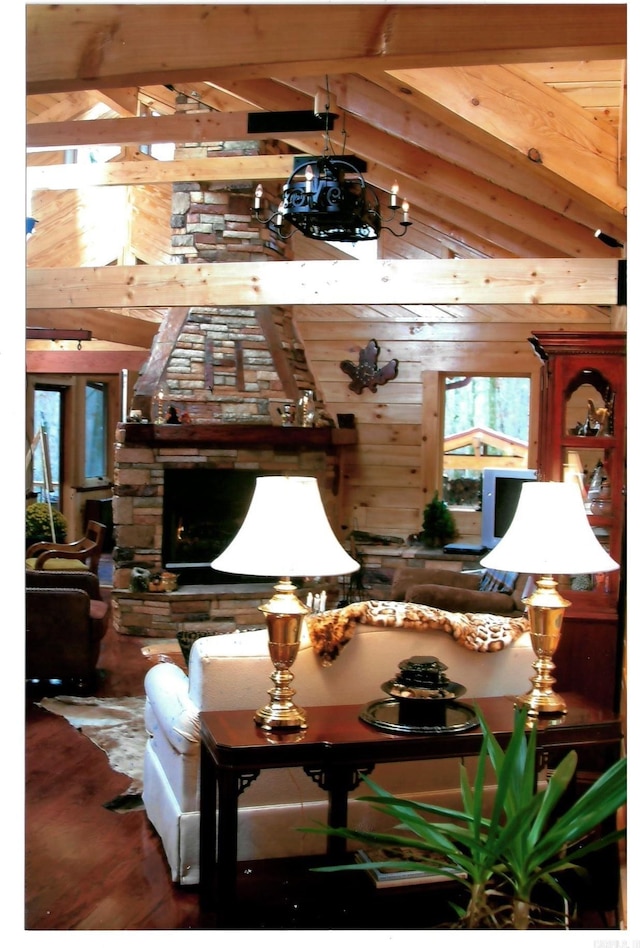 interior space with wood walls, lofted ceiling with beams, and wood finished floors