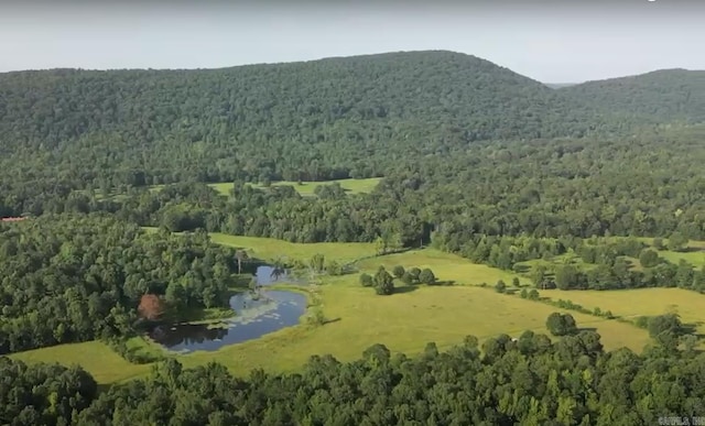 birds eye view of property with a wooded view and a water and mountain view