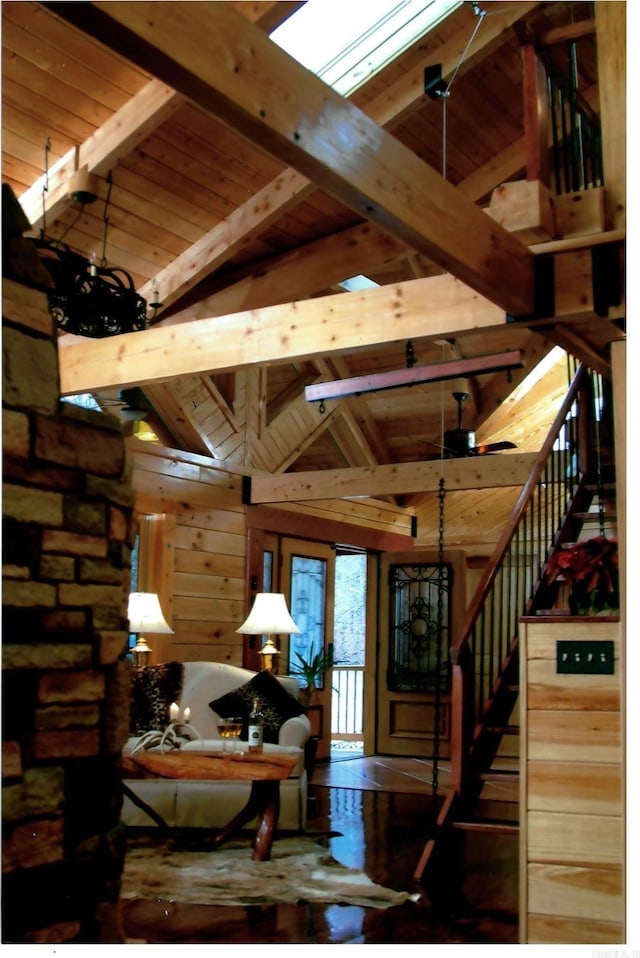 interior space with lofted ceiling with beams and stairway