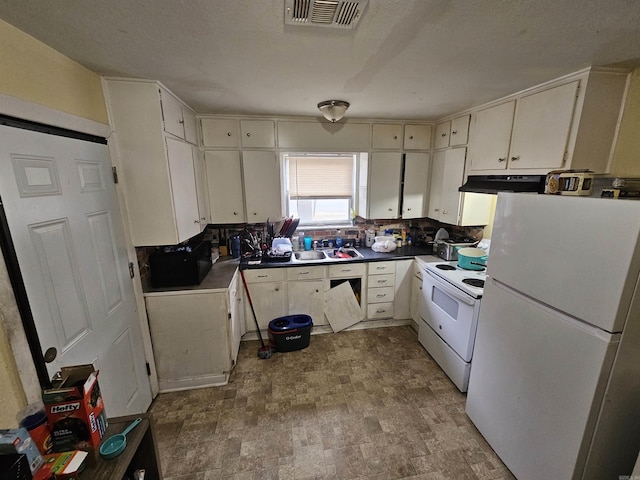 kitchen featuring white appliances, visible vents, decorative backsplash, dark countertops, and exhaust hood