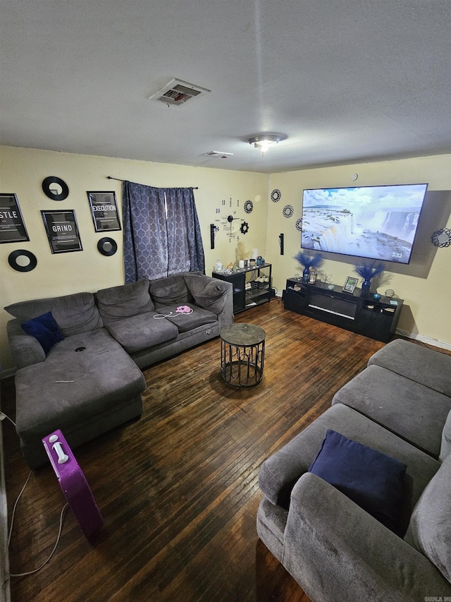 living room featuring visible vents and hardwood / wood-style floors