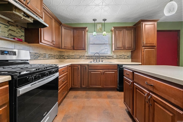 kitchen with an ornate ceiling, light countertops, under cabinet range hood, a sink, and gas stove