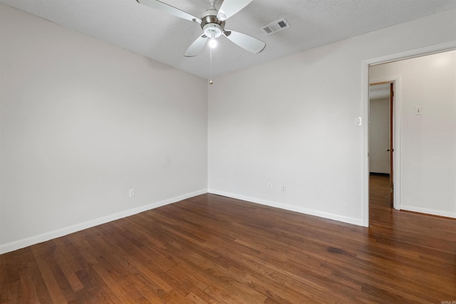 empty room with ceiling fan, a textured ceiling, wood finished floors, visible vents, and baseboards