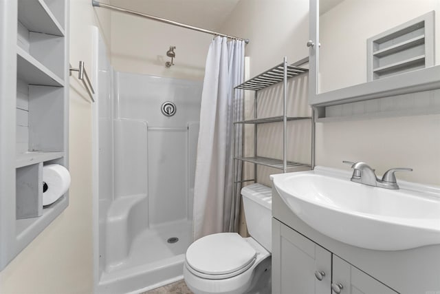 full bath with toilet, a stall shower, and vanity