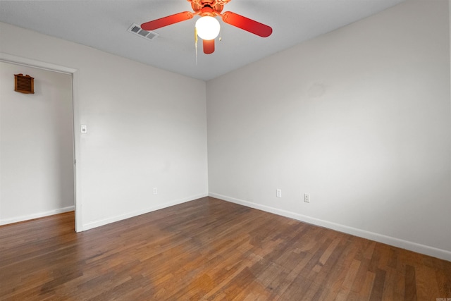 unfurnished room featuring visible vents, baseboards, and wood finished floors