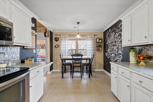 kitchen with visible vents, decorative backsplash, appliances with stainless steel finishes, light countertops, and white cabinetry