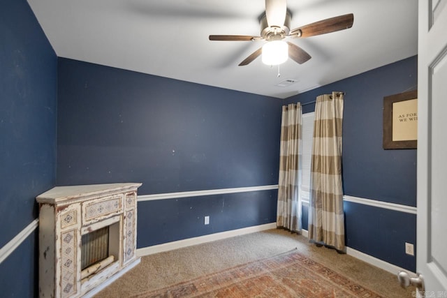 unfurnished living room with a ceiling fan, carpet flooring, visible vents, and baseboards