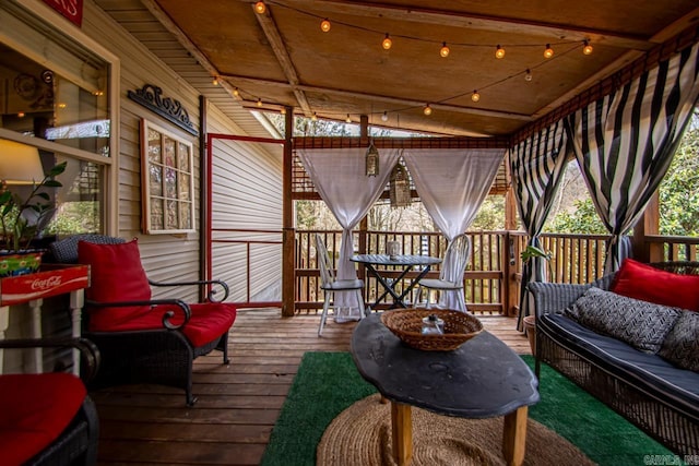 sunroom / solarium featuring track lighting