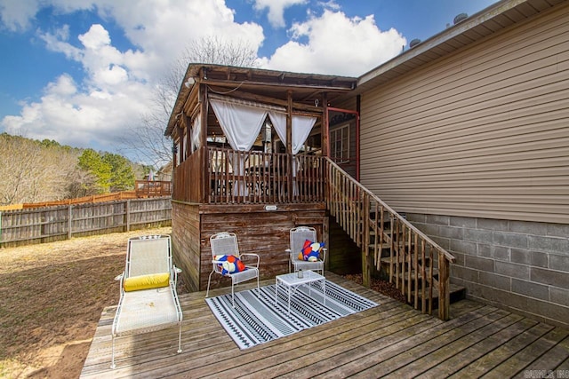 deck featuring stairs and fence