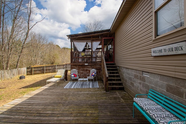 wooden terrace featuring stairs and fence private yard