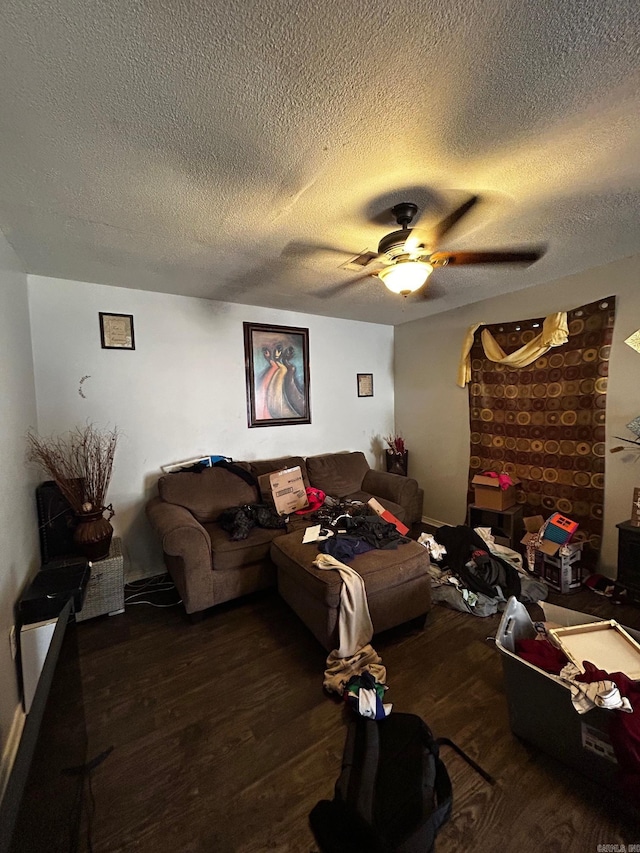 living room featuring ceiling fan, a textured ceiling, and wood finished floors