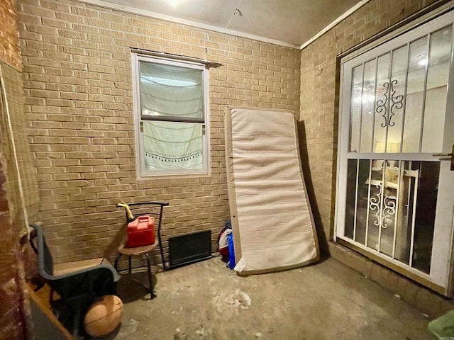 interior space with brick wall and concrete flooring