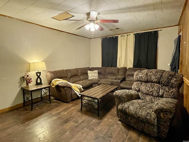 living room featuring baseboards, ceiling fan, ornamental molding, and wood finished floors