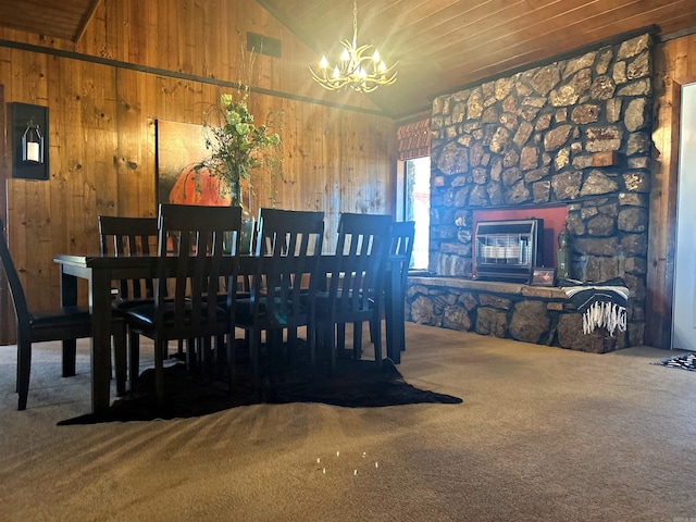 dining space featuring visible vents, lofted ceiling, carpet, wood walls, and a notable chandelier