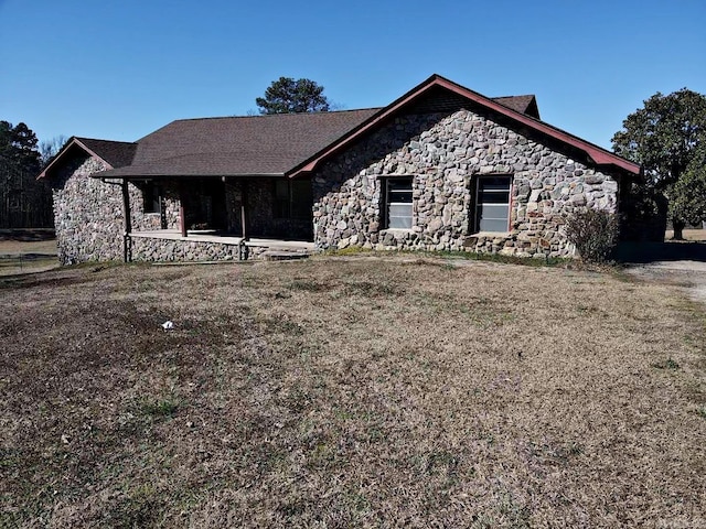 view of front of property featuring stone siding and a patio area