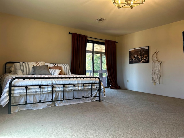 bedroom featuring carpet floors, visible vents, and an inviting chandelier