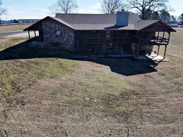 exterior space with stone siding, stairway, a patio area, and a wooden deck