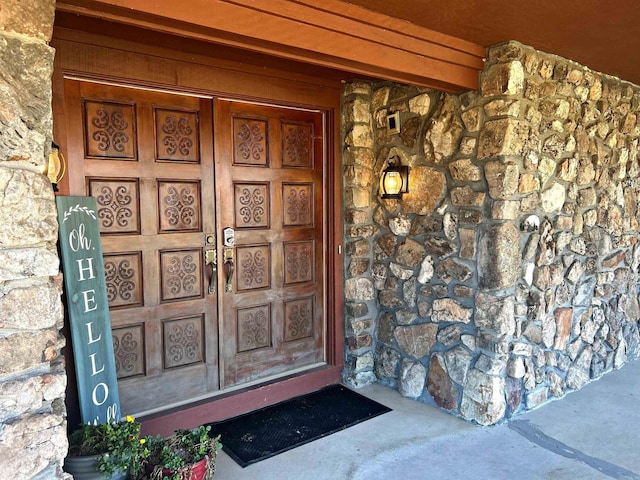 property entrance with stone siding