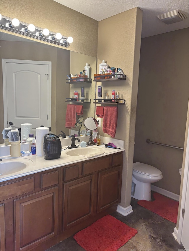 full bathroom with toilet, double vanity, visible vents, and a sink