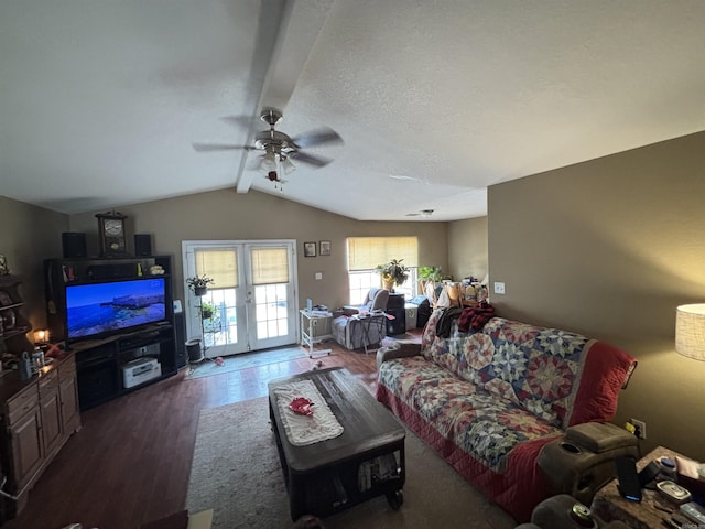 living area with french doors, vaulted ceiling with beams, a ceiling fan, a textured ceiling, and wood finished floors