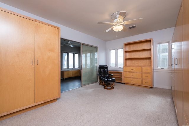 bedroom with carpet floors, visible vents, and a ceiling fan