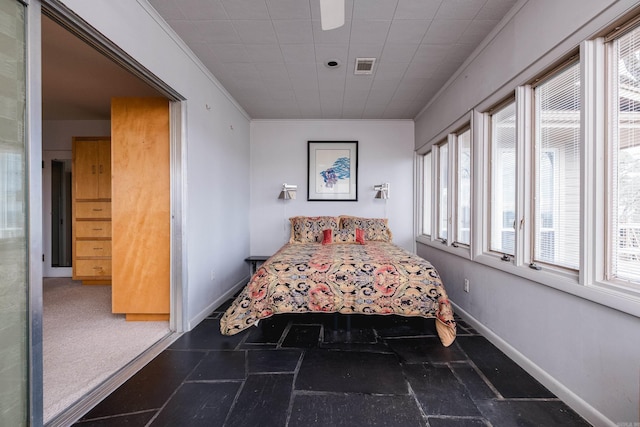 bedroom with ornamental molding, visible vents, and baseboards