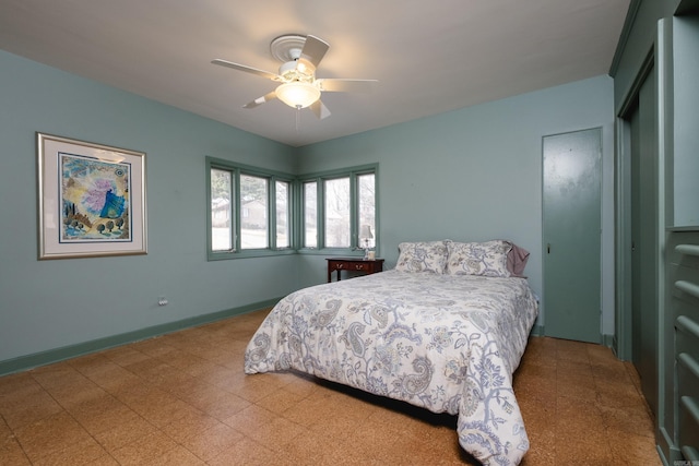 bedroom featuring ceiling fan, baseboards, and tile patterned floors