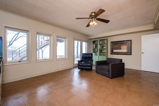 unfurnished room with crown molding, baseboards, and ceiling fan