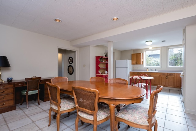 dining area with light tile patterned floors and recessed lighting